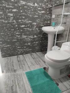 a bathroom with a white toilet and a sink at Hermosos Dptos Sunset Point Huanchaco in Huanchaco +43 photos