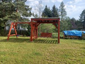 a wooden structure in a yard with a bench at LAWENDOVO in Nowinka