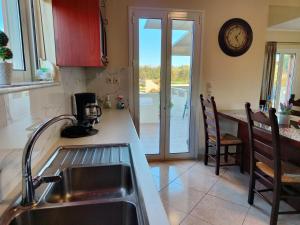 A kitchen or kitchenette at Pazinos/Neveli Cottage