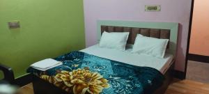 a bedroom with a bed with a flower on it at Hari Krishna Sadan paying guest House AYODHYA DHAM RAILWAY STATION in Faizābād
