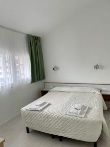 Säng eller sängar i ett rum på Hotel Giardino