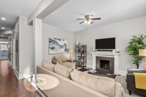 a living room with a couch and a fireplace at Walk to Forest Park Euclid Fire Pit Porch Swing in Tower Grove