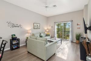 a living room with a couch and a table at Beautiful condo in Bahama Bay in Kissimmee