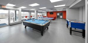 a conference room with a pool table and two tables at Residence & Conference Centre - King City in King City