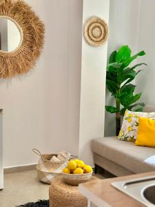 a living room with a bowl of oranges on the floor at Hotel Imperial in Dhërmi