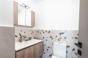 a bathroom with a sink and a toilet at Avras experience in Faraí +17 photos