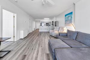 a living room with a couch and a table at Ocean Reef 904 by Emerald Coast Retreats in Panama City Beach