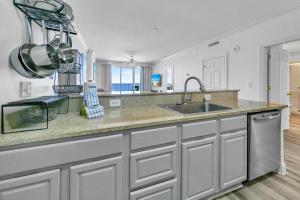 a kitchen with a sink and a counter at Ocean Reef 904 by Emerald Coast Retreats in Panama City Beach