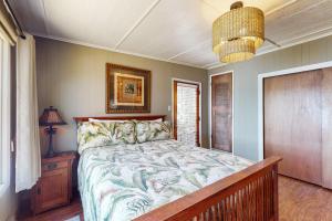 a bedroom with a bed and a chandelier at The Purple Beach House in Bremerton