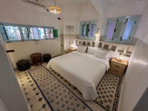 Кровать или кровати в номере Maison d'hôtes Dar Farhana