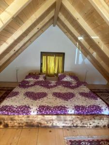 a bedroom with a purple bed in a attic at Vikendice Suvo Do in Berane