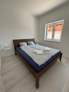 a bedroom with a bed with a mirror on it at SL Apartman Siófok in Siófok