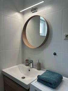 a bathroom with a sink and a mirror at SL Apartman Siófok in Siófok