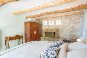 a bedroom with a bed and a fireplace at Domaine des Encourdoules in Vallauris