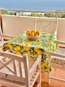 a table with a bowl of fruit on it at Hotel Imperial in Dhërmi