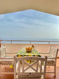 a table on a boat with a bowl of fruit on it at Hotel Imperial in Dhërmi