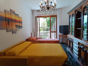 a bedroom with two beds and a chandelier at La Casa di Sisi in Rapallo +22 photos