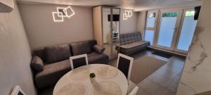 a living room with a couch and a table at M&S Ausros Apartments in Klaipėda