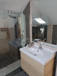 a bathroom with a white sink and a shower at Airport Loft , paiania in Paianía +2 photos