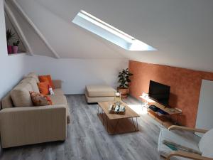 a living room with a couch and a tv at Airport Loft , paiania in Paianía