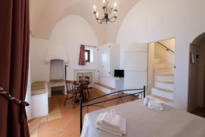 a kitchen and living room with a table and a staircase at Masseria Borgo Santuri in Ostuni