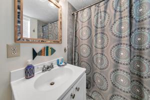 a bathroom with a sink and a shower at Beach Haven by Emerald Coast Retreats in Panama City Beach