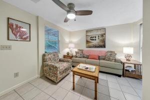 a living room with a couch and a chair at Beach Haven by Emerald Coast Retreats in Panama City Beach