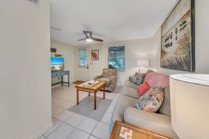 a living room with a couch and a table at Beach Haven by Emerald Coast Retreats in Panama City Beach