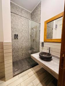 a bathroom with a sink and a glass shower at Siwa Sunrise Hotel in Siwa