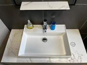 a white sink with a toothbrush and a cup on it at Enroom in Zambratija +27 photos