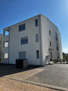 a white building with a black box in front of it at Enroom in Zambratija