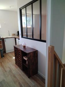 a room with a table and a mirror on the wall at Le havre de Paix Appartement T2 in Mazères +9 photos