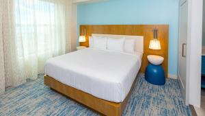 a bedroom with a large bed and a blue vase at Holiday Inn Club Vacations Myrtle Beach Oceanfront in Myrtle Beach
