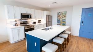 a kitchen with white cabinets and a blue island at Holiday Inn Club Vacations Myrtle Beach Oceanfront in Myrtle Beach
