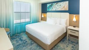 a hotel room with a large bed and a window at Holiday Inn Club Vacations Myrtle Beach Oceanfront in Myrtle Beach