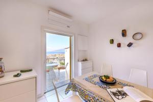 a kitchen and dining room with a table and a window at Ester's home Sorrento in Sorrento