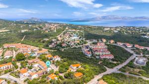 an aerial view of a town on a hill next to the ocean at Isthintini-Parcheggio gratuito in Stintino