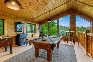 a room with a pool table in a cabin at Dawns View in Sevierville