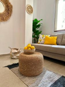 a living room with a basket of oranges on a table at Hotel Imperial in Dhërmi