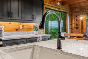 a kitchen with a sink and a faucet at Dawns View in Sevierville
