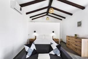 een slaapkamer met een zwart-wit bed en houten kasten bij Casa Celestina in Temisas