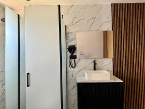 La salle de bains est pourvue d'un lavabo et d'un miroir. dans l'établissement Boutique Palacio, à Alicante