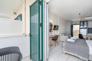 een woonkamer met een groene deur en een tafel bij Sunset Premium Studio 8 in Ayios Nikitas