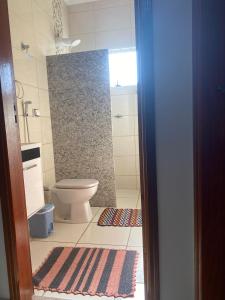 a bathroom with a toilet and a shower at lolahouse in Monte Sião +14 photos