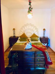 a bedroom with a large bed with a dresser at Beautiful small House in Algarve Portugal in Mexilhoeira Grande +18 photos