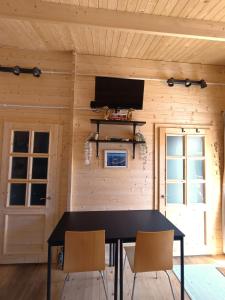 a dining room with a black table and two chairs at Dreamholia in Jastarnia
