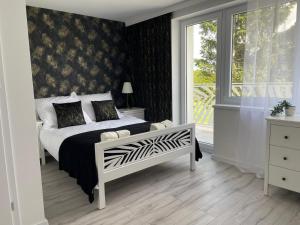 a bedroom with a bed and a large window at Horse Ville in Pawłów