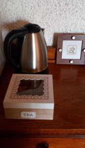 a tea kettle and a box on a table at Appartamento panoramico Casa Gerro in Averara