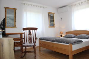 1 dormitorio con cama, silla y escritorio en Vacation House Home, Plitvice Lakes National Park en Lagos de Plitvice
