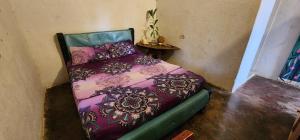 a bed sitting in a corner of a room at LA PIRATA Casa Hostel in Palomino